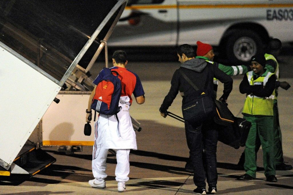 France's national team's Franck Ribery (L) and Andre-Pierre Gignac board a plane at the airport of George on June 23, 2010 a day after the team lost their last Group A first round 2010 World Cup football match against host South Africa and did not qualified foe the next round of the tournament. Disgusted but no longer surprised by their team's dismal World Cup performance, many French fans cheered South Africa's goals as "Les Bleus" were dumped out of the competition. AFP PHOTO / FRANCK FIFE (Photo by FRANCK FIFE / AFP)