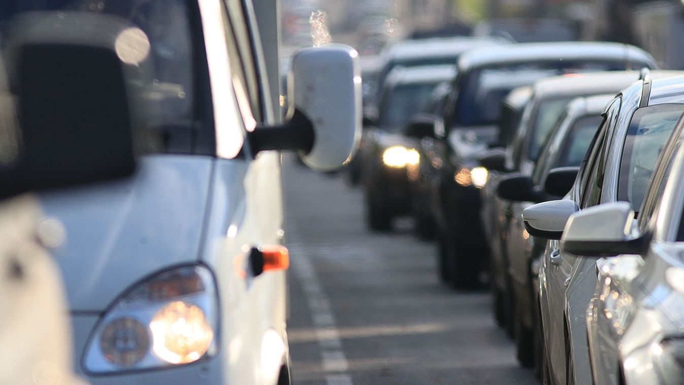 traffic on the road in a European city, stopping 