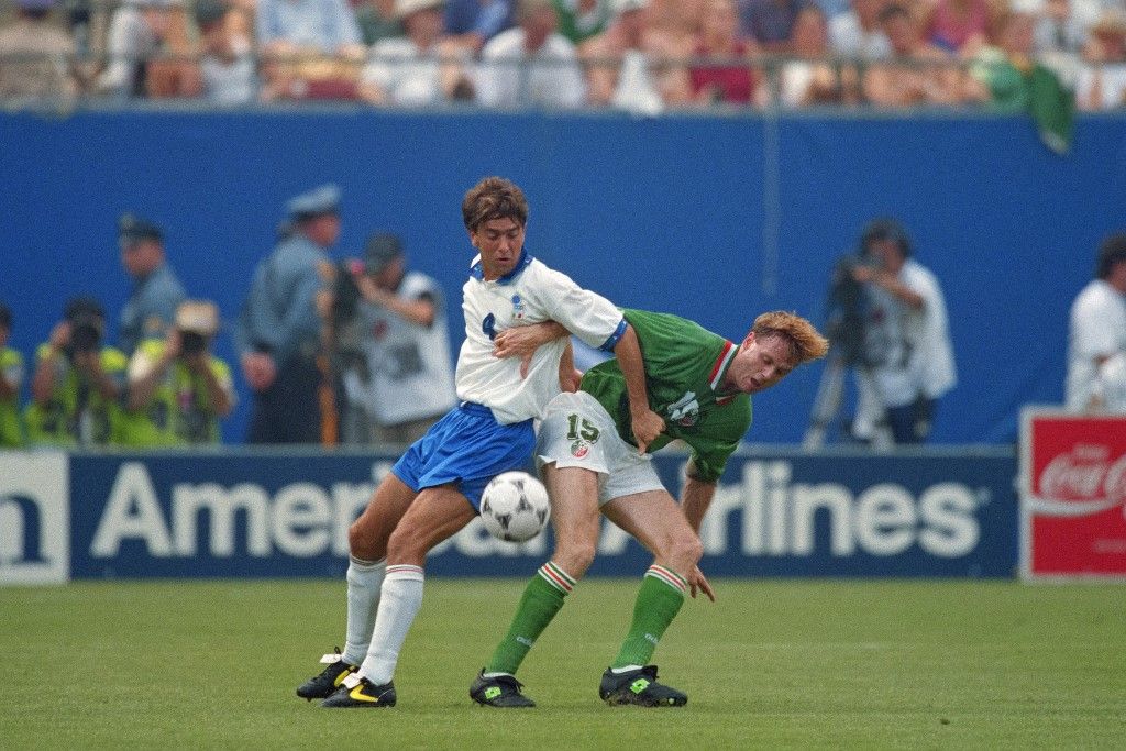 Italy's Alessandro Costacurta (L) and Ireland's Tommy Coyne fight for the ball during the match between Italy and Ireland of the 15th World Cup football at Giants stadium in East Rutherford on June 18, 1994. The 15th FIFA World Cup took place in 1994. The United States hosted the event, which was held at nine locations nationwide from June 17 to July 17, 1994. Despite soccer's relative lack of popularity in the host country, the United States was selected, and the competition was the most profitable in World Cup history. (Photo by Jean-Loup GAUTREAU / AFP)