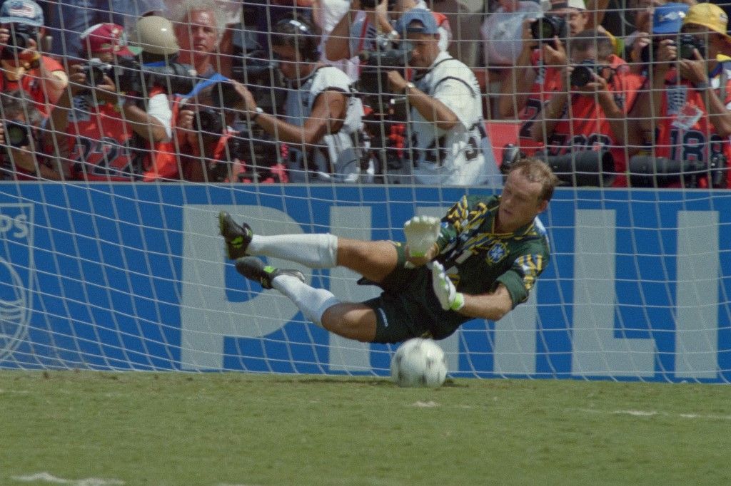 Brazil's goalkeeper Claudio Taffarel dives to stop the penalty kick of Italy's Daniele Massaro during the shout-out of the final match between Brazil and Italy of the 15th World Cup football at Rose Bowl stadium in Pasadena on July 17, 1994. The 15th FIFA World Cup took place in 1994. The United States hosted the event, which was held at nine locations nationwide from June 17 to July 17, 1994. Despite soccer's relative lack of popularity in the host country, the United States was selected, and the competition was the most profitable in World Cup history. (Photo by Gabriel BOUYS / AFP)