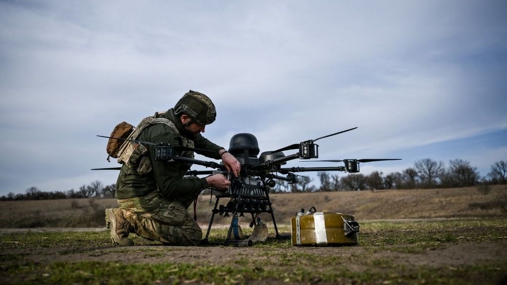 A soldier from a drone unit of Ukraine's 422nd Separate Unmanned Systems Regiment ''Luftwaffe'' prepares a Baba Yaga heavy bomber drone before a daytime training flight in the Zaporizhzhia direction, Ukraine, on March 23, 2026. (Photo by Dmytro Smolienko/Ukrinform/NurPhoto) (Photo by Dmytro Smolienko / NurPhoto via AFP)