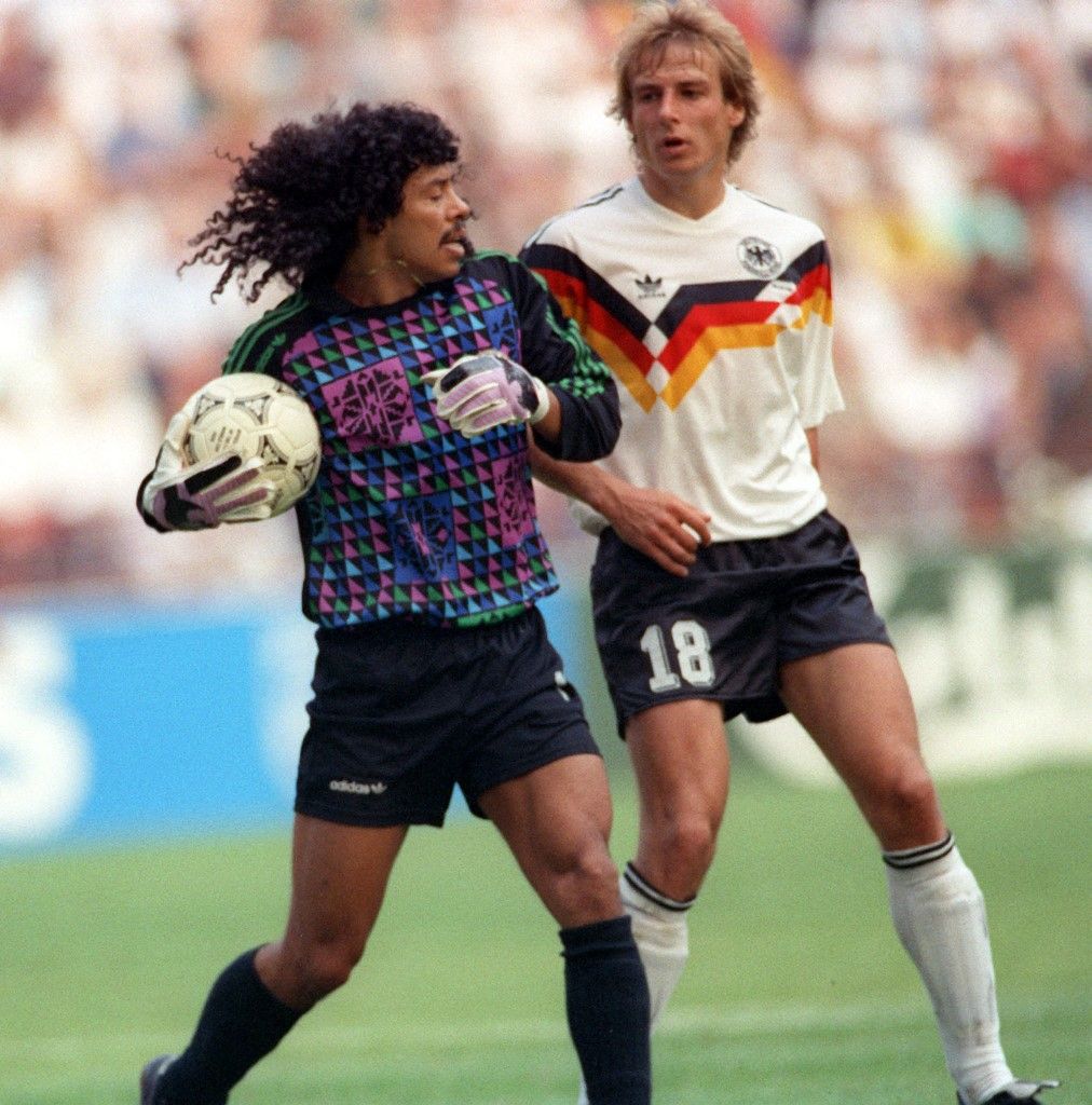 German striker Juergen Klinsmann and Colombian goalkeeper Rene Higuita, who holds on to the ball provocatively long. The match ends with a 1:1 tie in Milan's Giuseppe-Meazza stadium and group winner Germany enters the next round of the 1990 FIFA World Cup in Italy. (Photo by FRANK LEONHARDT / dpa Picture-Alliance via AFP)