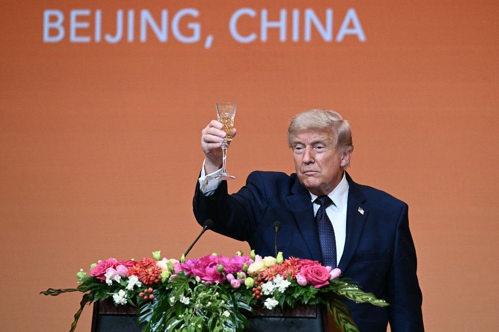US President Donald Trump makes a toast as he attends a state banquet with China's President Xi Jinping at the Great Hall of the People in Beijing on May 14, 2026. (Photo by Brendan SMIALOWSKI / AFP)