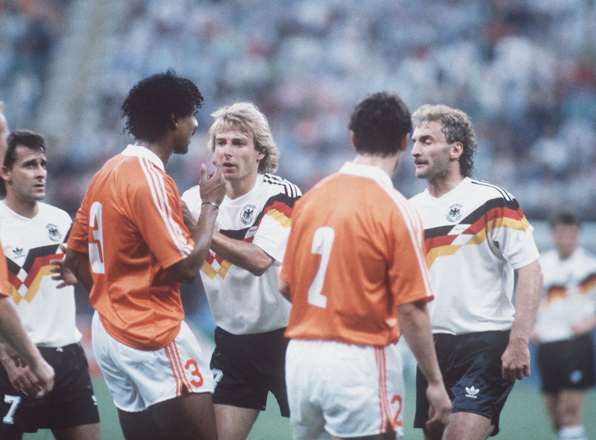 Juergen KLINSMANN, Germany, keeps Frank RIJKAARD, Netherlands, from running at Rudi VOELLER, Germany during the 1990 FIFA World Cup in Italy (Photo by SVEN SIMON / dpa Picture-Alliance via AFP)