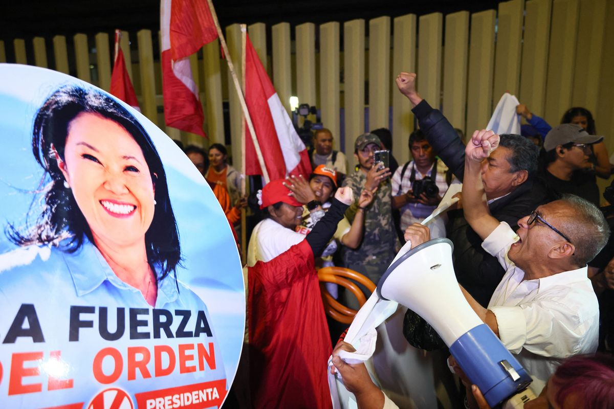Supporters of Peru's presidential candidate Keiko Fujimori, for the Fuerza Popular party, shout slogans outside the Lima Convention Center ahead of her debate with Roberto Sanchez, for the Juntos por el Peru party, in Lima on May 31, 2026. Peru will hold the presidential runoff election on June 7. (Photo by Connie FRANCE / AFP)