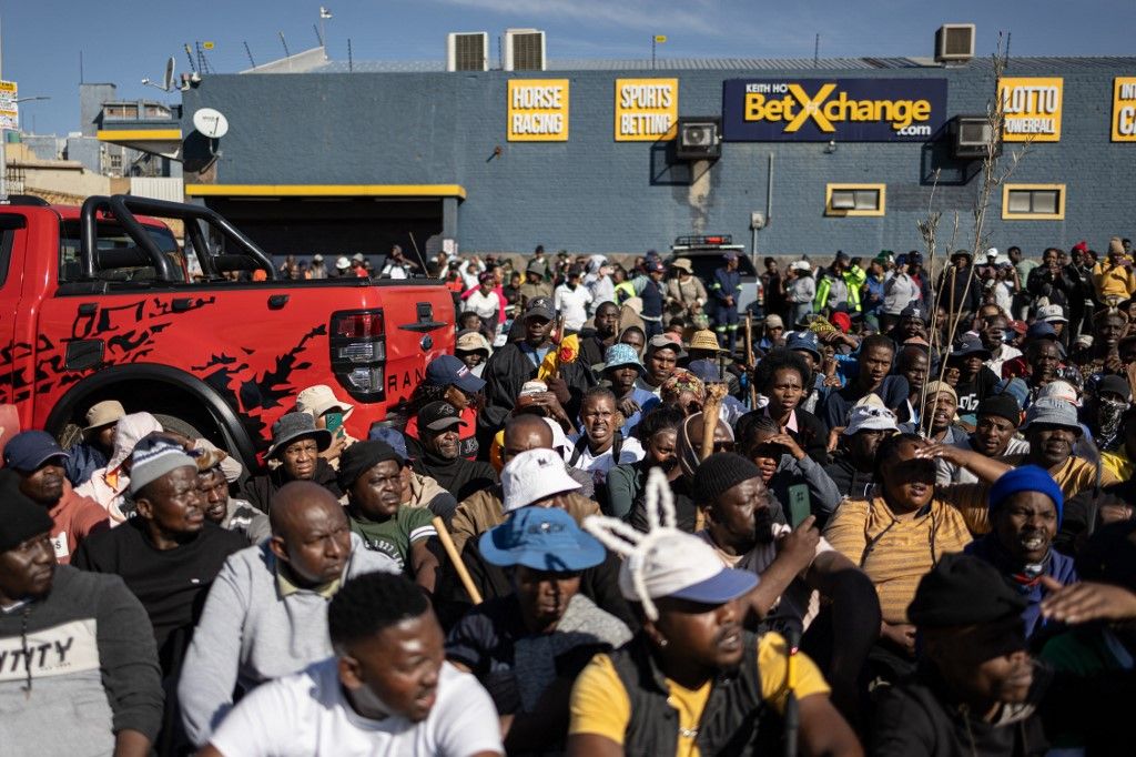Protesters gather during a protest march against undocumented migrants in Springs, Ekurhuleni, on June 8, 2026. Hundreds of anti-migrant protesters marched through a township outside Johannesburg on June 8, 2026, a day after South African President Cyril Ramaphosa pledged action against groups accused of fuelling xenophobic violence.
South Africa has seen recurring bouts of anti-migrant violence, with protests intensifying this year after vigilante groups ordered undocumented foreigners to leave by June 30. (Photo by EMMANUEL CROSET / AFP)