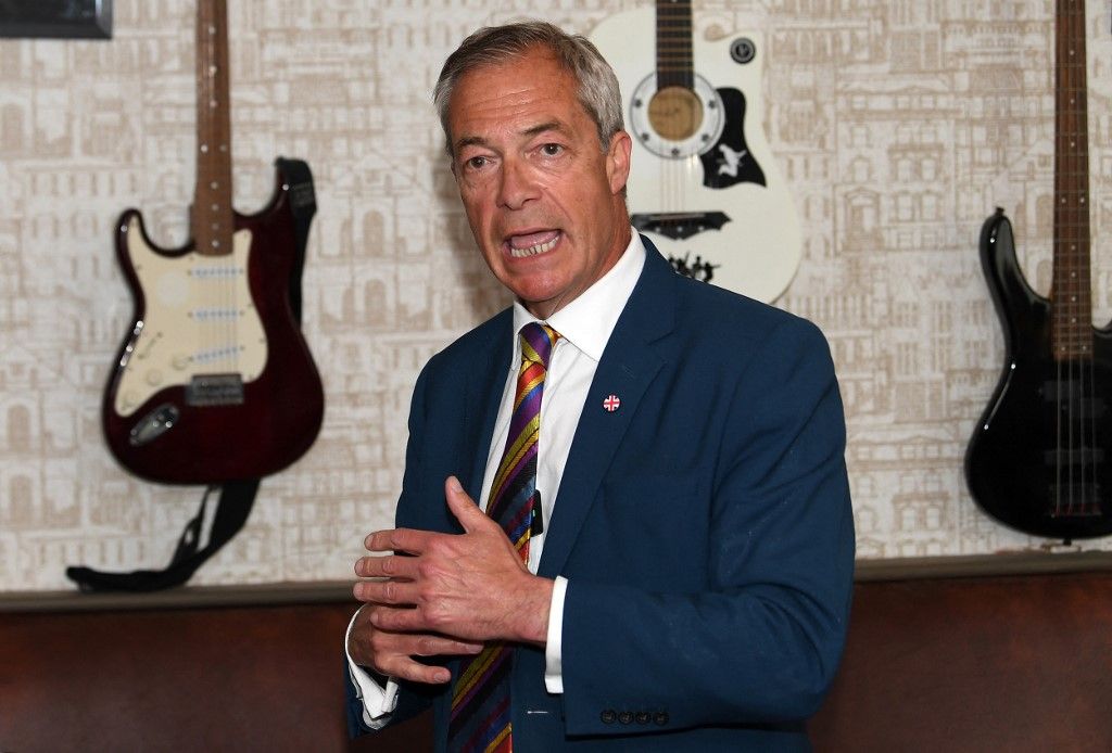 Reform UK leader Nigel Farage speaks inside the Dam Bar & Grill in St Helens, north west England on May 8, 2026, as votes continue to be counted following local elections. Nigel Farage, leader of the Britain's hard-right nationalist Reform UK party, vowed Friday it was "here to stay" after winning hundreds of seats in local polls. (Photo by PETER POWELL / AFP)