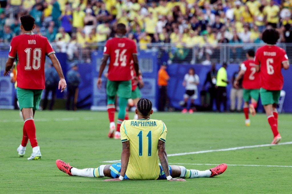 Brazil's forward #11 Raphinha sits on the ground during the 2026 World Cup Group C football match between Brazil and Morocco at the New York/New Jersey Stadium in East Rutherford on June 13, 2026. (Photo by TIMOTHY A. CLARY / AFP)