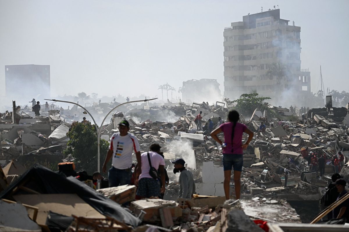 Volunteers search for possible victims in a collapsed building following twin earthquakes in Caraballeda, La Guaira state, some 40 km northeast of Caracas, on June 25, 2026. The death toll from twin quakes, measured at magnitudes 7.2 and 7.5, has risen to at least 188, with more than 1,520 others injured, top lawmaker Jorge Rodriguez reported, while residents continue searching for missing relatives. (Photo by Federico PARRA / AFP)