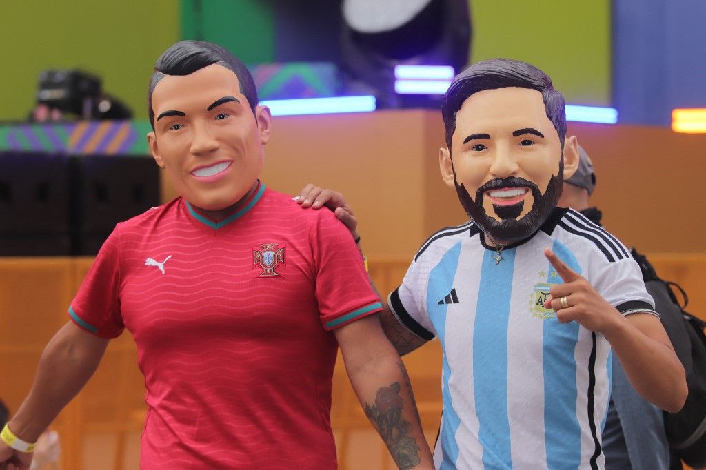 Fans of the Argentina and Portugal national teams wear Lionel Messi and Cristiano Ronaldo masks to support their respective teams at the Mexico FIFA Fan Fest in the main square Zocalo on June 17, 2026, in Mexico City, Mexico. (Photo by Carlos Santiago/Eyepix Group/NurPhoto) (Photo by Eyepix / NurPhoto via AFP)