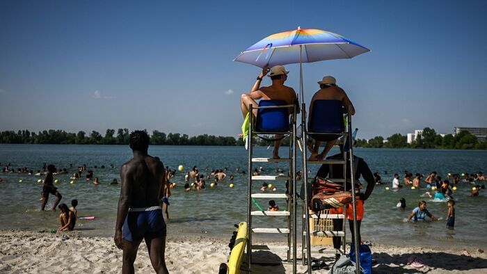 Lifeguards keep watch from their station over a packed lake beach during a heatwave at the Bordeaux Lac beach, in Bordeaux, south-western France on June 23, 2026. France on June 23, 2026 experienced its hottest day since measurements began in 1947, the na