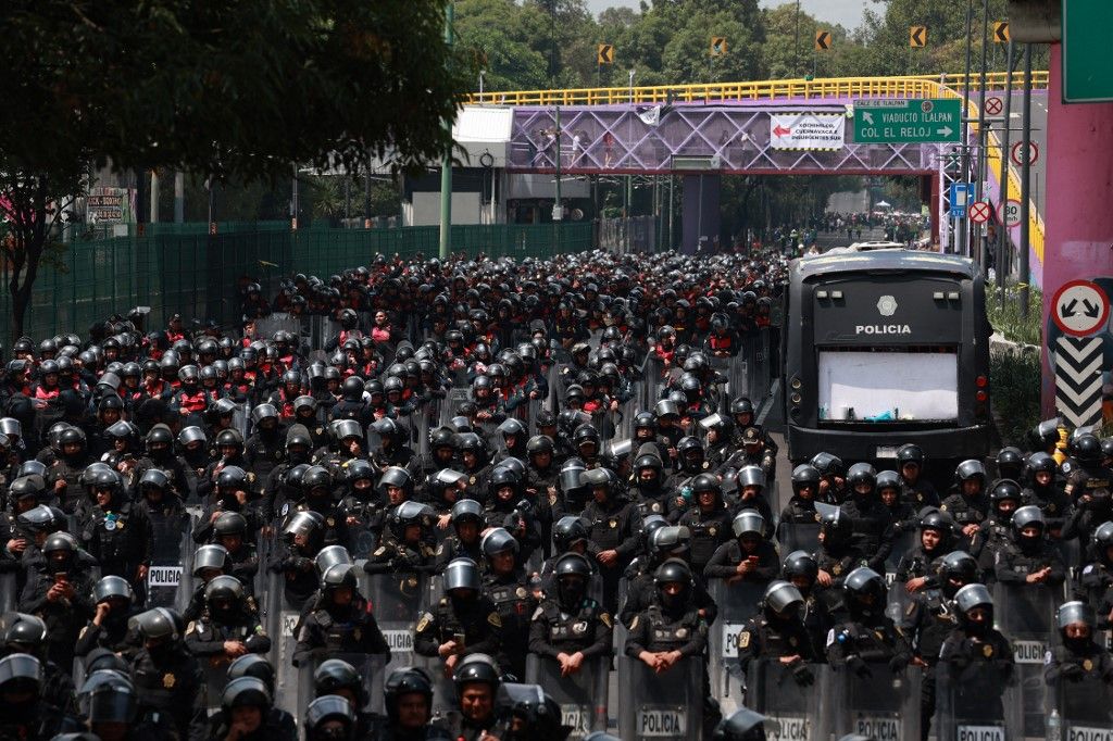 MEXICO CITY, MEXICO - JUNE 11: Riot police secure the area during a protest against the World Cup, in Mexico City, Mexico on June 11, 2026. Thousands of demonstrators marched toward Banorte Stadium to protest against the World Cup, while some clashed with riot police outside the stadium where the World Cup opener was taking place. Daniel Cardenas / Anadolu (Photo by Daniel Cardenas / Anadolu via AFP)