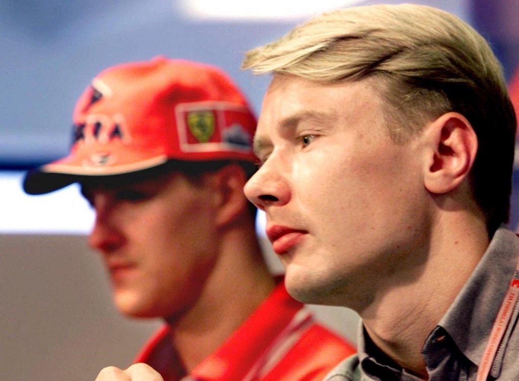 German Ferrari driver Michael Schumacher (L) and Finnish McLaren-Mercedes driver and current leader of the championship Mika Hakkinen listen to journalist's questions during a press conference, 13 August on the Hungaroring, one day before the start of the free practice sessions of the formula one Grand Prix of Hungary scheduled on 16 August. (ELECTRONIC IMAGE) (Photo by Eric CABANIS / AFP)