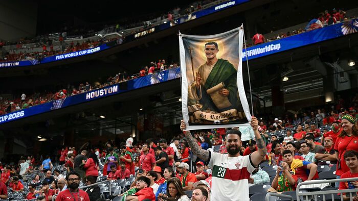 Lugas 0711
A Portugal supporter poses with banner depicting Portugal's forward #07 Cristiano Ronaldo as a Saint in the tribunes prior to the 2026 World Cup Group K football match between Portugal and the Democratic Republic of Congo at the Houston Stadi