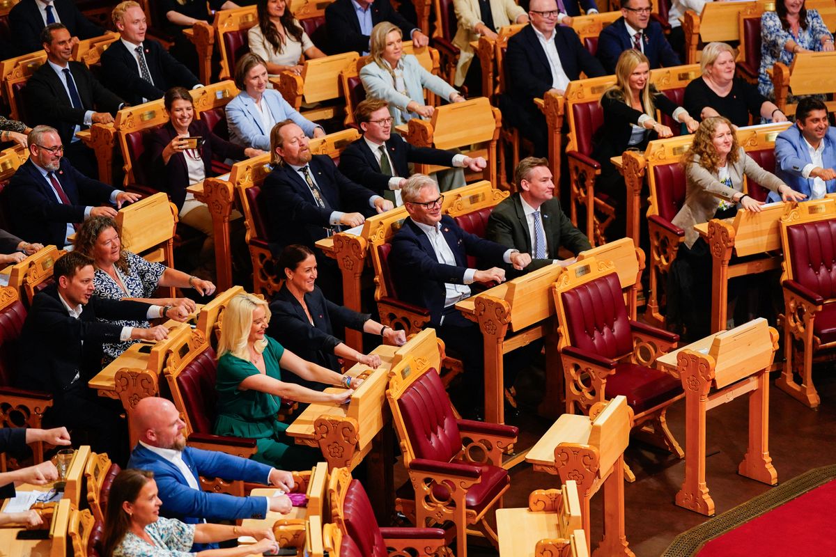 Members of Norway's Parliament make the 'Viking rowing' action, as seen done by fans of the Norwegian national football team at the World Cup in the USA, at the Storting Parliament in Oslo on June 18, 2026. (Photo by Håkon Mosvold Larsen / NTB / AFP) / Norway OUT