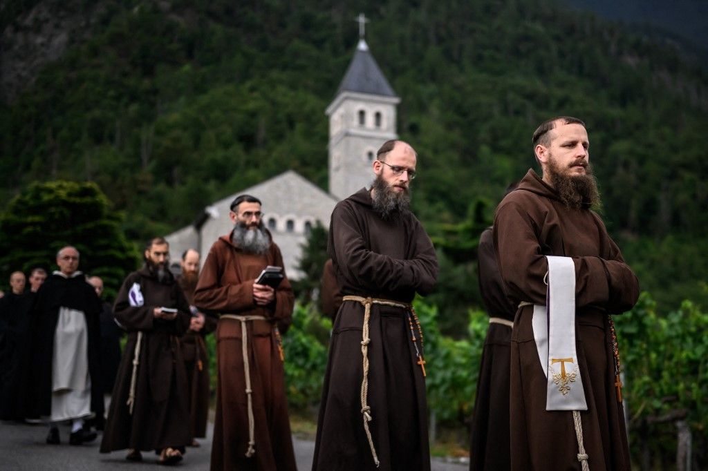 Traditionalist Catholic monks parade in the procession before the schismatic consecration of bishops by the traditionalist Catholic Society of Saint Pius X (SSPX) in Econe, western Switzerland, on July 1, 2026. The Society of Saint Pius X consecrated four new bishops on July 1, 2026, in defiance of Pope Leo XIV, who pleaded with the ultra-traditionalist breakaway group to turn back from what he called a "schismatic act" with Rome. (Photo by Fabrice COFFRINI / AFP)
