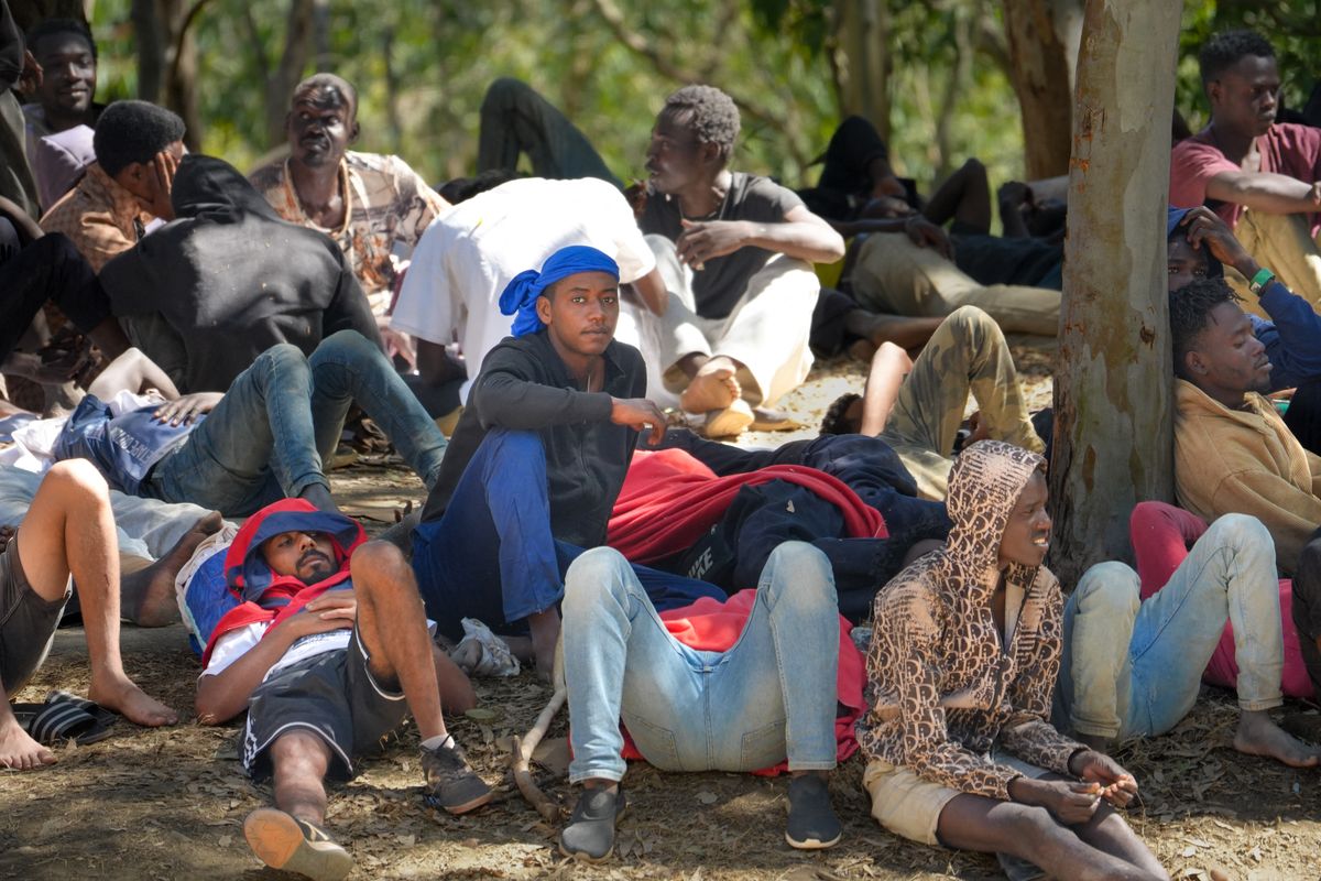 Migrants wait outside the Temporary Stay Center for Immigrants (CETI) in Ceuta, Spain, on August 2, 2026, as the facility operates at full capacity. Those without available places remain outside in the hope of being admitted. (Photo by Ana Lopez/NurPhoto) (Photo by Ana Lòpez / NurPhoto via AFP)