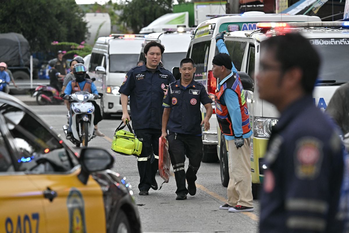 Emergency responders gather outside a school following a shooting in Bang Kruai district, Nonthaburi province, north of Thailand's capital Bangkok, on August 7, 2026. Two people were killed and 15 wounded in a school shooting in a province just north of the Thai capital Bangkok on August 7, local media reported. (Photo by Lillian SUWANRUMPHA / AFP)