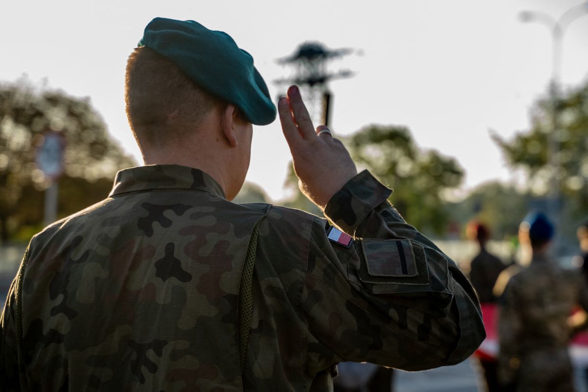 A Polish soldier salutes during a general rehearsal of the land component ahead of the Polish Armed Forces Day (Swieto Wojska Polskiego) military parade on the Wislostrada in Warsaw, Poland, on August 9, 2026.  (Photo by Marek Antoni Iwanczuk/NurPhoto) (Photo by Marek Antoni Iwa?czuk / NurPhoto via AFP)
