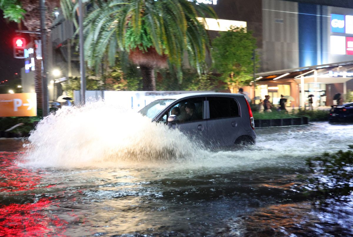 A road is flooded due to heavy rain in Ichikawa City, Chiba Prefecture, adjacent to Tokyo, on August 13, 2026. Torrential rain is falling across various parts of Chiba Prefecture, and the Japan Meteorological Agency has issued Heavy rain special warning. ( The Yomiuri Shimbun ) (Photo by Tosei Kisanuki / The Yomiuri Shimbun via AFP)