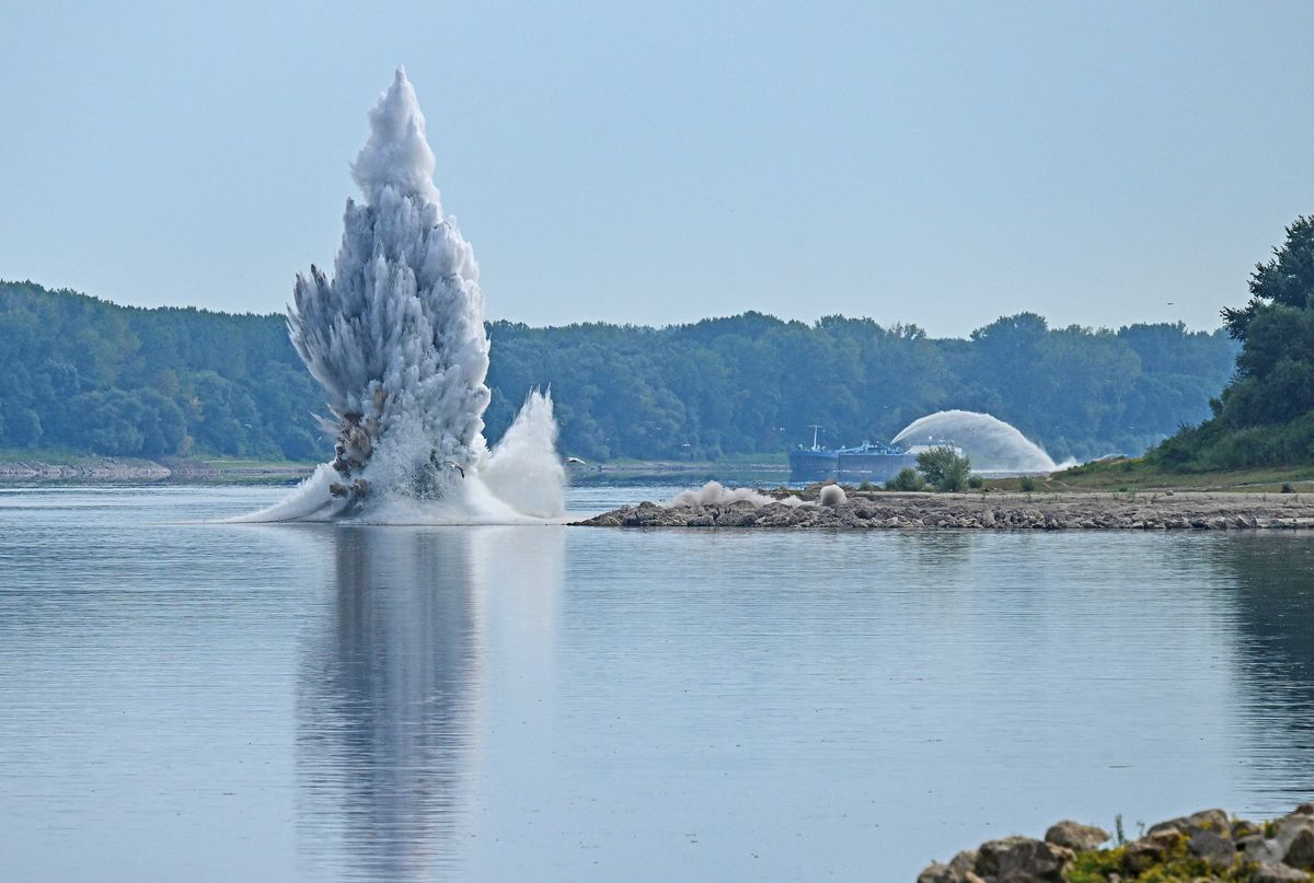 A controlled underwater explosion is pictured on the riverbed of the Danube River in Izvoarele village, on August 3, 2026. The blast aimed at deepening the channel and diverting a higher volume of water toward the cooling systems of the Cernavoda Nuclear Power Plant. Local authorities and plant engineers authorized the blasting operations to counteract critically low water levels caused by a prolonged summer heatwave, ensuring the continuous and safe operation of the facility's reactors. (Photo by Daniel MIHAILESCU / AFP)