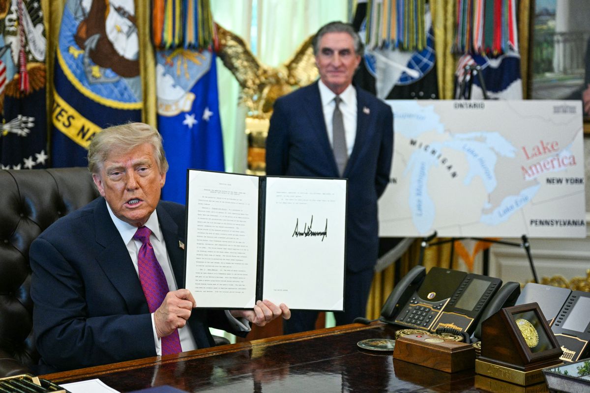 US President Donald Trump, alongside Secretary of the Interior Doug Burgum, displays an executive order he signed that aims to rename Lake Ontario to Lake America in the Oval Office of the White House in Washington, DC, on August 27, 2026. President Donald Trump announced Thursday that he is renaming Lake Ontario -- a large body of water shared by the United States and Canada -- "Lake America." Trump signed an order in the White House, telling reporters the change was "effective immediately." (Photo by Jim WATSON / AFP)