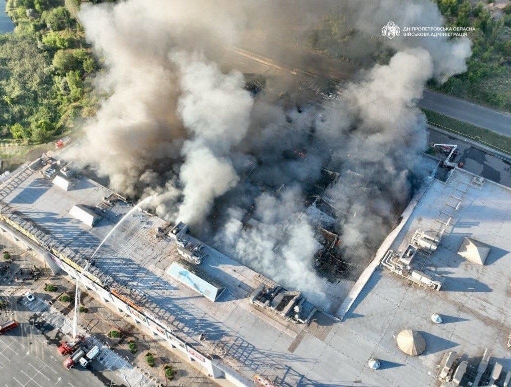This handout photograph taken and released by the Dnipropetrovsk Regional Military Administration on August 21, 2026 shows firefighters taking part in operations against a fire at the site of a shopping mall damaged following a Russian strike in Kryvyi Rih amid the Russian invasion of Ukraine. Ukrainian President on August 21, 2026, blasted Russia for a "cynical and despicable" attack on a shopping centre in his home town that killed at least five people and wounded more than 50. (Photo by Handout / Dnipropetrovs'k Regional Military Administration / AFP) / RESTRICTED TO EDITORIAL USE - MANDATORY CREDIT "AFP PHOTO /  DNIPROPETROVSK REGIONAL MILITARY ADMINISTRATION" - HANDOUT - NO MARKETING NO ADVERTISING CAMPAIGNS - DISTRIBUTED AS A SERVICE TO CLIENTS