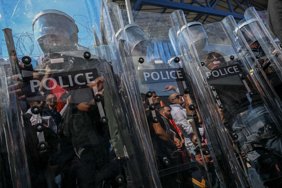Riot police officers stand guard  as people protest in front of the EULEX headquarters in Pristina on September 16, 2026, after the Kosovo Specialist Chambers in The Hague convicted former Kosovo president Hashim Thaci and three former guerrilla commanders of war crimes. Kosovo's former president Hashim Thaci was sentenced to 25 years by a tribunal in The Hague on September 16, 2026 for war crimes, the court said in a long-awaited verdict likely to spark outrage in the Balkan country. (Photo by Armend NIMANI / AFP)