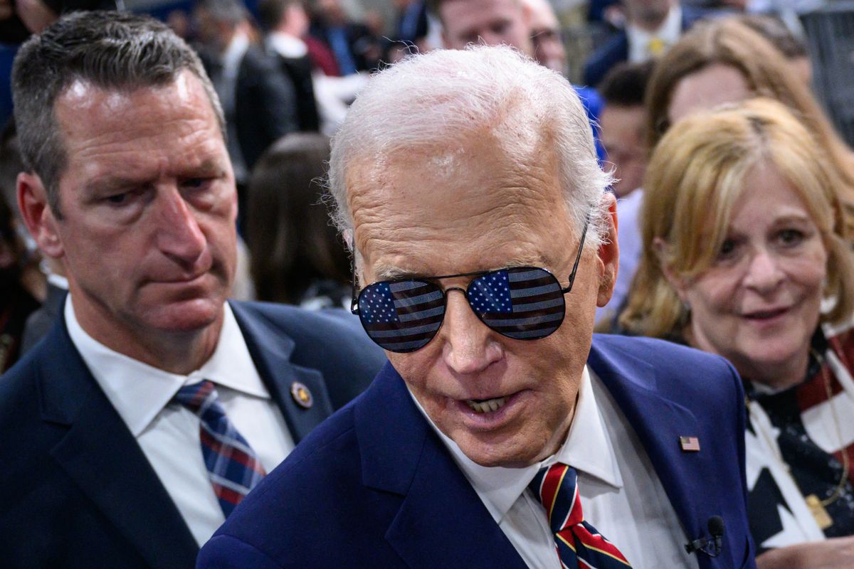 US President Joe Biden wears sunglasses given to him by supporters after speaking on the PACT Act, which expands coverage for veterans exposed to toxic substances, at the Westwood Park YMCA in Nashua, New Hampshire, on May 21, 2024. (Photo by Mandel NGAN / AFP)