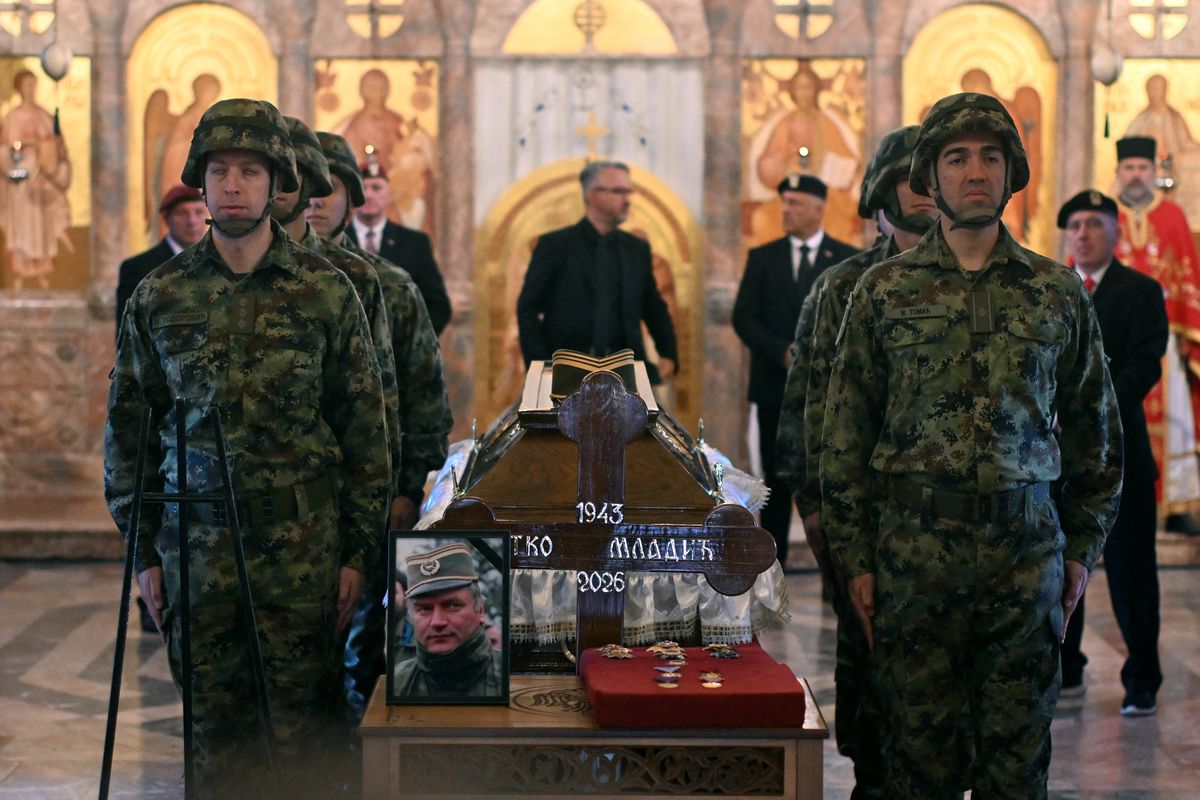 Serbian armed forces stand guard as Darko Mladic stands in front of the coffin of his father while taking part in a public memorial on the day of the funeral ceremony for late Bosnian Serb military leader Ratko Mladic at St Lukas church in Belgrade, on September 7, 2026. Mladic, 84, died last week after suffering several strokes while serving a life sentence in The Hague for war crimes committed during the 1990s war in Bosnia. (Photo by OLIVER BUNIC / AFP)