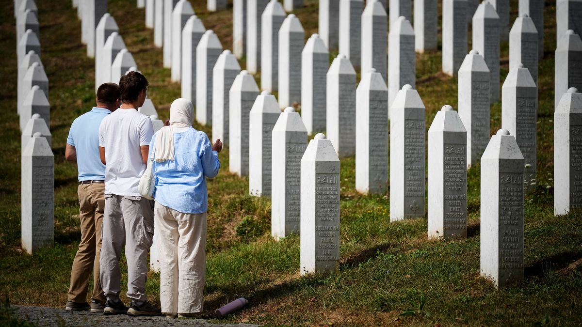 Visitors stand at the memorial cemetery in the village of Potocari, following the death of former Bosnian Serb military chief Ratko Mladic near the eastern Bosnian town of Srebrenica, on August 28, 2026. Mladic died in a prison hospital in The Hague aged 84 after suffering several strokes. He was priorly convicted of genocide, crimes against humanity and war crimes, was known as the "Butcher of Bosnia" for his role in the 1995 Srebrenica massacre, Europe's worst atrocity since World War II. (Photo by Nidal Saljic / AFP)