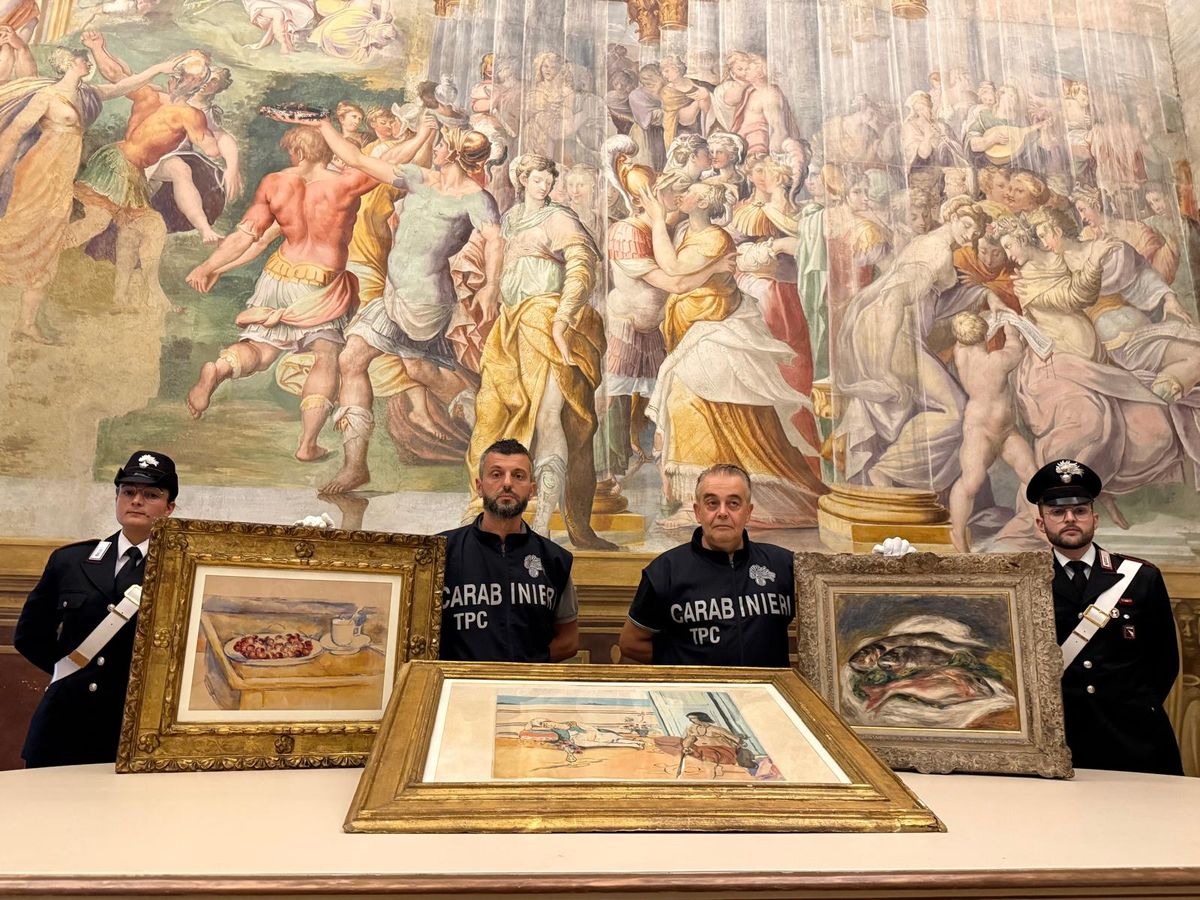 This photograph taken and released on August 14, 2026, by the Carabinieri from the Parma Provincial Command, shows Carabinieri TPC art squad officers of the Parma Provincial Command posing with recovered valuable artworks by Paul Cezanne (L) Pierre-Auguste Renoir (R) and Henri Matisse stolen on March 23, 2026, from the Fondazione Magnani Rocca Museum in Traversetolo, near Parma. Carabinieri from the Parma Provincial Command and the Cultural Heritage Protection Unit have recovered the three paintings: Tasse et plat de cerises (pencil and watercolor on white paper, 380x490 mm) by Post-Impressionist artist Paul Cezanne (estimated value: 6,000,000); Les Poissons (oil on canvas, 40 x 51.5 cm) by Impressionist artist Pierre-Auguste Renoir, signed and dated Renoir 1917 at the bottom right (estimated value: approx. 3,000,000); and Odalisque sur la terrasse (color aquatint on *Velin d'Arches* paper, 63 x 91 cm overall) by Modernist artist Henri Matisse (estimated value: 20,000). (Photo by Handout / ITALIAN CARABINIERI PRESS OFFICE / AFP) / RESTRICTED TO EDITORIAL USE - MANDATORY CREDIT "AFP PHOTO /HANDOUT/ ITALIAN CARABINIERI PRESS OFFICE" - HANDOUT - NO MARKETING NO ADVERTISING CAMPAIGNS - DISTRIBUTED AS A SERVICE TO CLIENTS
