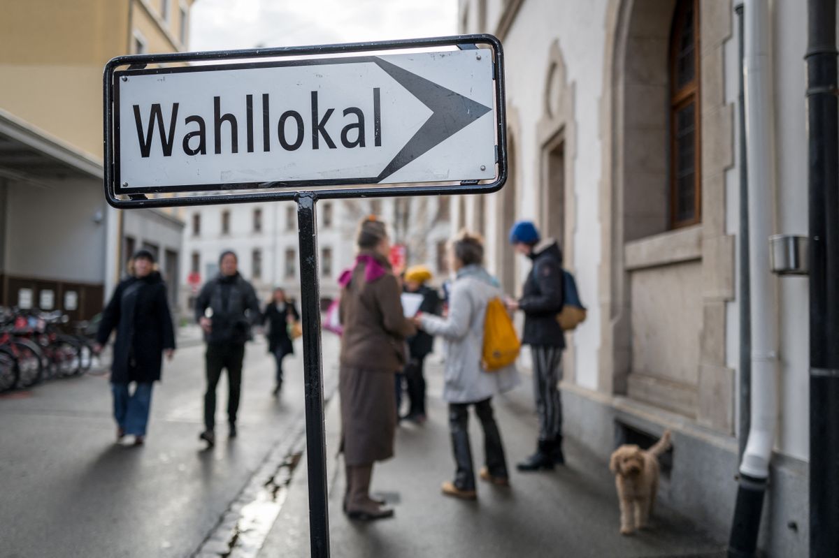 A sign showing the way to a polling station is photographed in Basel, northern Switzerland, on November 24, 2024. Voters in the Swiss city of Basel comfortably approved putting nearly $40 million into hosting the 2025 Eurovision Song Contest, according to intermediate results shortly after the polls closed. (Photo by Fabrice COFFRINI / AFP)
