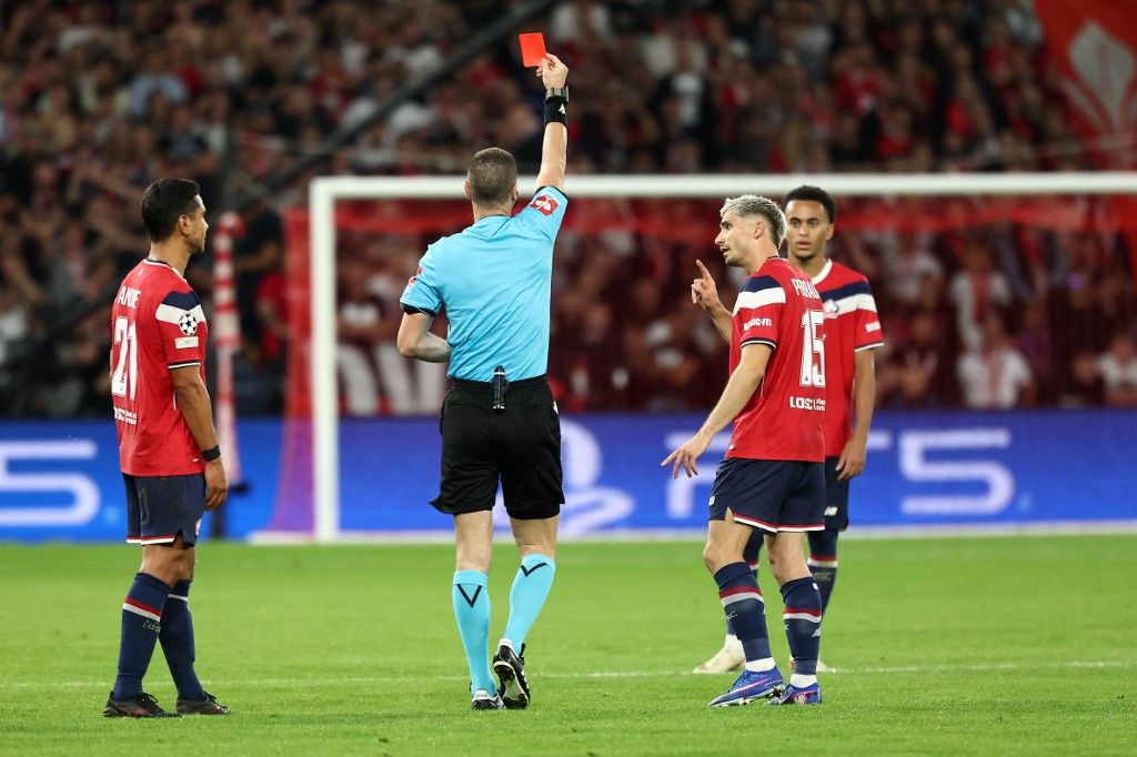 Bulgarian referee Georgi Kabakov (C) shows Lille's French forward #08 Ethan Mbappe (R) a red card for a foul on Real Betis' Spanish midfielder #08 Pablo Fornals (not pictured) during the UEFA Champions League, league phase day 1, football match between Lille (FRA) and Real Betis (ESP) at the Stade Pierre Mauroy, in Villeneuve d'Ascq, on September 8, 2026. (Photo by Sameer AL-DOUMY / AFP)