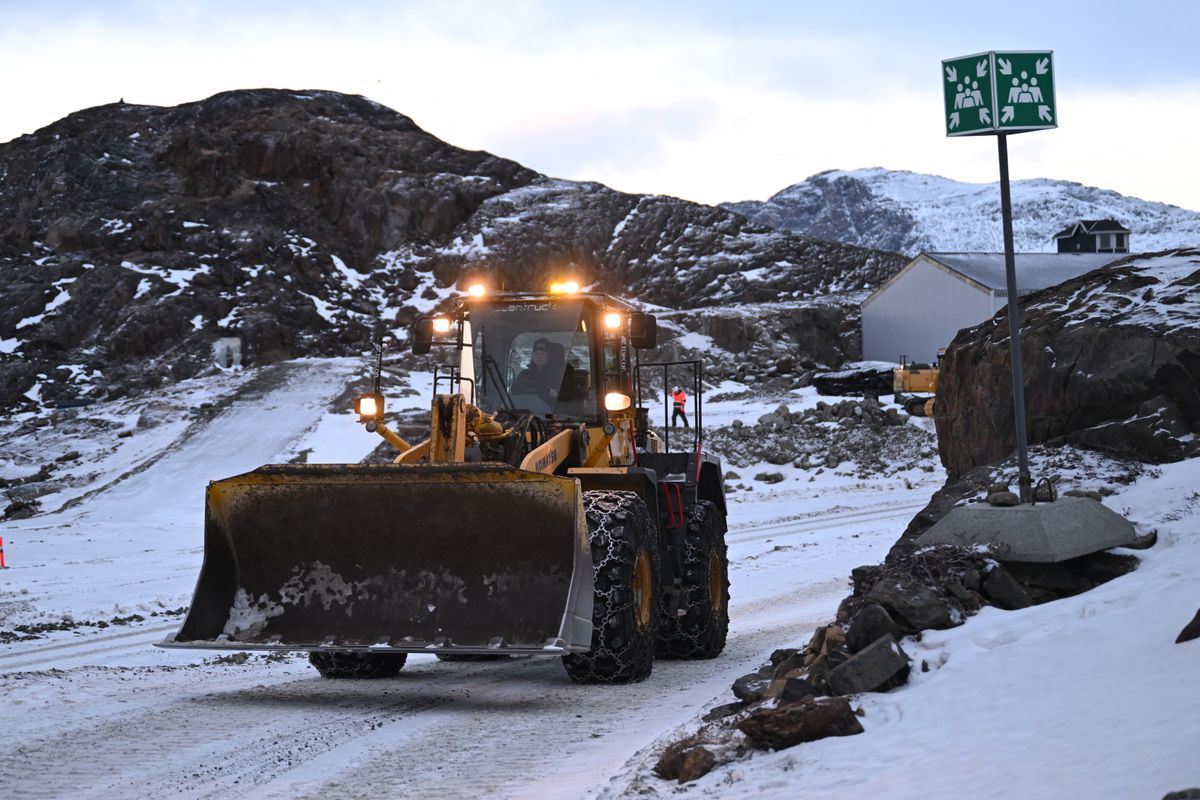 A student practices driving a shovel excavator on the school grounds of the Greenland School of Minerals and Petroleum in Sisimiut, Greenland on February 2, 2026. The purpose and ambition of Greenland School of Minerals and Petroleum (GSMP) is to ensure a skilled workforce for the Greenlandic mining and construction industries. The school offers students international courses during four years apprenticeship programs "skilled manual miner" and "skilled operator of construction equipment". (Photo by Ina FASSBENDER / AFP)