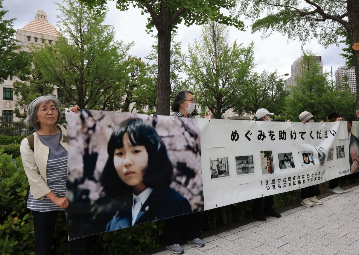 On June 4, 2026, members of a private assistance group for abductees and their families, known as "Asagao no Kai" (which translates to "Group of Morning Glory" in English), hold the banner and demand the rescue of Megumi Yokota, one of the abduction victims by North Korea, in silence near the Diet building in Chiyoda Ward, Tokyo. June 4 was the sixth anniversary of the death of Megumi's father, Shigeru Yokota. ( The Yomiuri Shimbun ) (Photo by Kota KAWASAKI / The Yomiuri Shimbun via AFP)