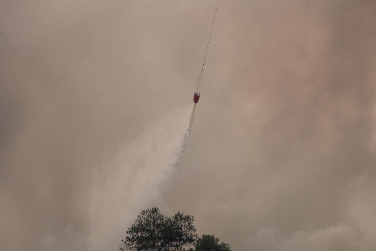 A helicopter operated by Indonesia's National Disaster Management Agency conducts a water bombing at Sungai Rambutan Regency in Ogan Ilir, South Sumatera, Indonesia, on September 12, 2026. El Nino conditions are helping to fuel wildfires across Indonesia, leaving some 113,336 people with respiratory illnesses according to the country's health officials. High-intensity wildfires on Indonesia's Borneo and Sumatra islands are worsening air quality and affecting neighbouring countries in South East Asia, including Malaysia, Singapore and the Philippines. (Photo by Muhammad Fajri/NurPhoto) (Photo by Muhammad Fajri / NurPhoto via AFP)