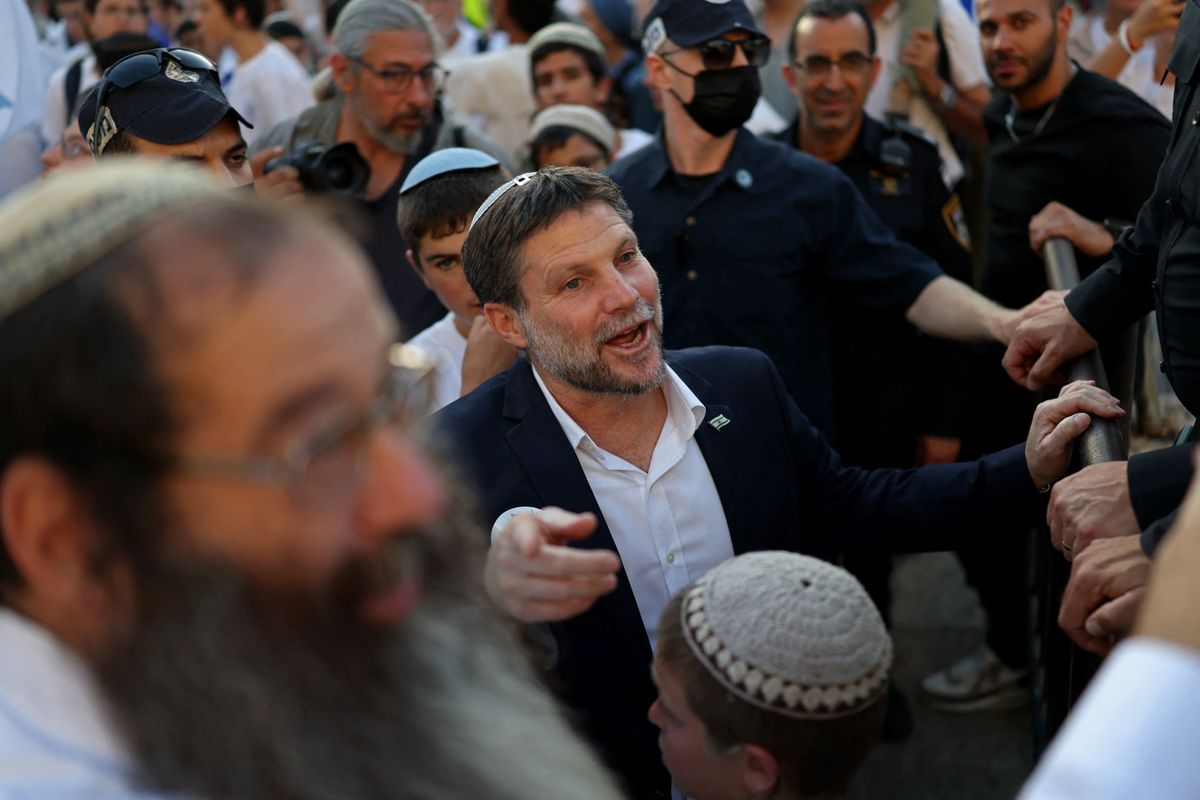 Israel's Finance Minister Bezalel Smotrich (C) takes part in the Jerusalem Day parade at the Damascus Gate in the old city of Jerusalem on May 14, 2026. Every year, thousands of Israeli nationalists, many of them religious Jews, march through Jerusalem and its annexed Old City, including in predominantly Palestinian neighbourhoods, waving Israeli flags, dancing and sometimes shouting inflammatory slogans. (Photo by Ilia YEFIMOVICH / AFP)