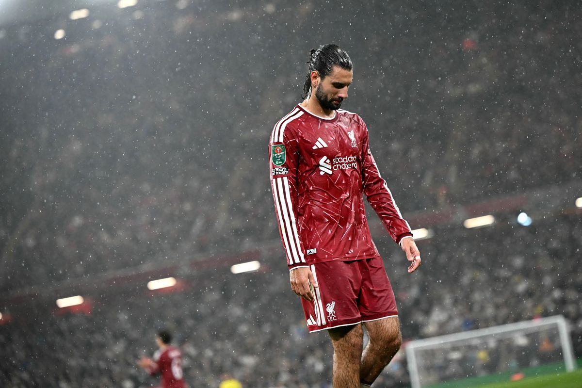 Rain falls as Liverpool's Hungarian midfielder #08 Dominik Szoboszlai walks to the corner flag during the English League Cup third round football match between Liverpool and Tottenham Hotspur at Anfield stadium in Liverpool, north west England on September 15, 2026. (Photo by Paul ELLIS / AFP) / RESTRICTED TO EDITORIAL USE. No use with unauthorized audio, video, data, fixture lists, club/league logos or 'live' services. Online in-match use limited to 120 images. An additional 40 images may be used in extra time. No video emulation. Social media in-match use limited to 120 images. An additional 40 images may be used in extra time. No use in betting publications, games or single club/league/player publications. / 